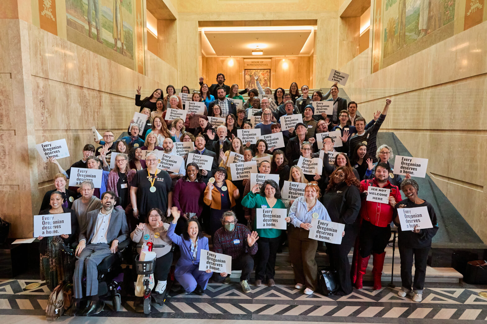 Housing advocates gathered at the Oregon State House holding signs reading 'Every Oregonian deserves a home.'